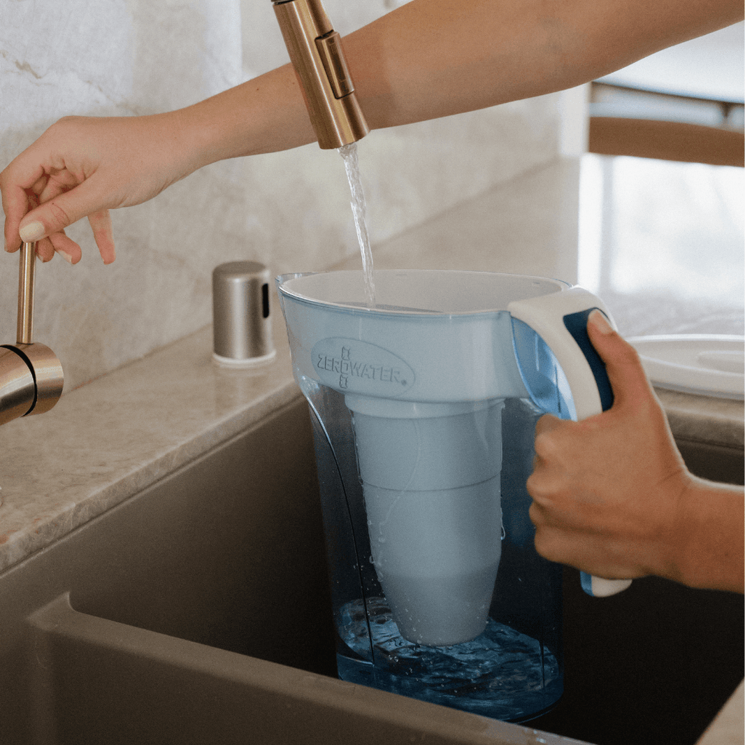 Filling a water filter pitcher at the kitchen sink